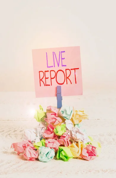 Writing note showing Live Report. Business photo showcasing continuous stream of updates that are published in real time Reminder pile colored crumpled paper clothespin wooden space. — Stockfoto