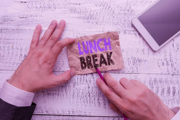 Conceptual hand writing showing Lunch Break. Business photo showcasing time when a demonstrating stops working or studying to have lunch Hand hold note paper near writing equipment and smartphone.