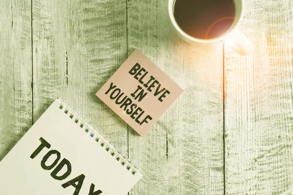 Word writing text Believe In Yourself. Business concept for Encouraging someone Selfconfidence Motivation quote Stationary placed next to a cup of black coffee above the wooden table.