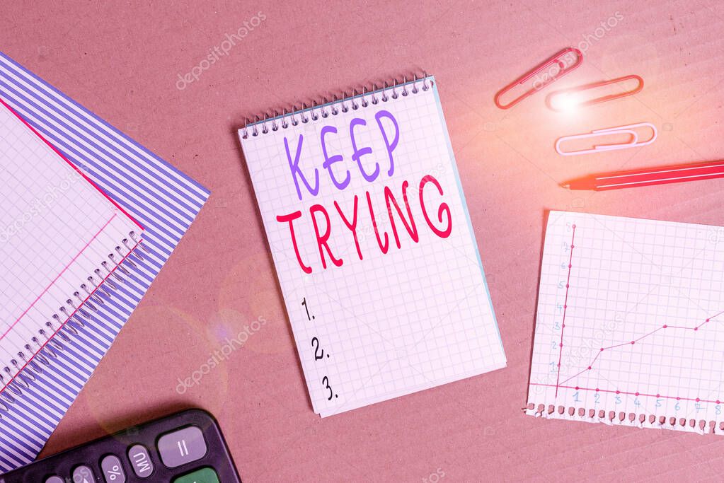 Handwriting text writing Keep Trying. Concept meaning continue to do something or to do something again and again Striped paperboard notebook cardboard office study supplies chart paper.