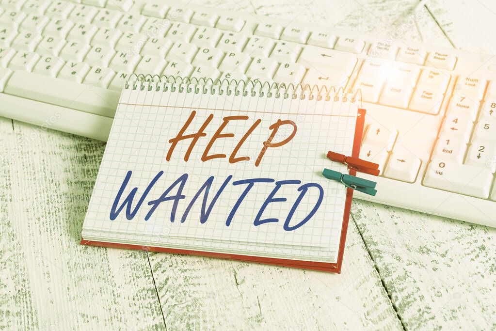 Handwriting text writing Help Wanted. Concept meaning An ad in the paper an employer places to find a new employee notebook paper reminder clothespin pinned sheet white keyboard light wooden.