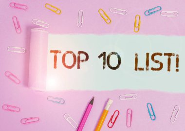 Top 10 Listesini gösteren not yazılıyor. Özel bir listedeki en önemli ya da en başarılı on parçayı gösteren iş fotoğrafı. Klasik bir masa arkaplanı üzerinde duran sabit ve yırtık karton..