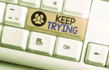 Text sign showing Keep Trying. Conceptual photo continue to do something or to do something again and again White pc keyboard with empty note paper above white background key copy space.