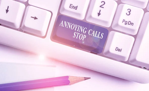 Conceptual hand writing showing Annoying Calls Stop. Business photo showcasing Prevent spam phones Blacklisting numbers Angry caller White pc keyboard with note paper above the white background. — Stock Photo, Image