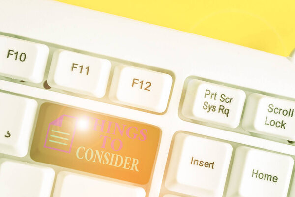 Writing note showing Things To Consider. Business photo showcasing list to check or do it Shopping Schedule Time table White pc keyboard with note paper above the white background.