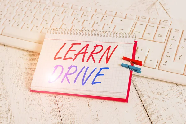 Handwriting text writing Learn Drive. Concept meaning to gain the knowledge or skill in driving a motor vehicle notebook paper reminder clothespin pinned sheet white keyboard light wooden. — Stock Photo, Image