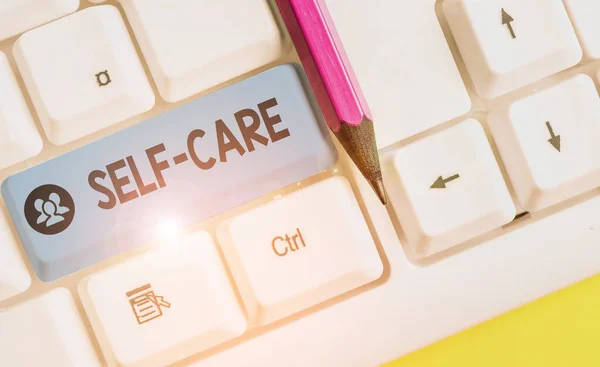 Handwriting text Self Care. Concept meaning the practice of taking action to improve one s is own health White pc keyboard with empty note paper above white background key copy space. — Stock Photo, Image