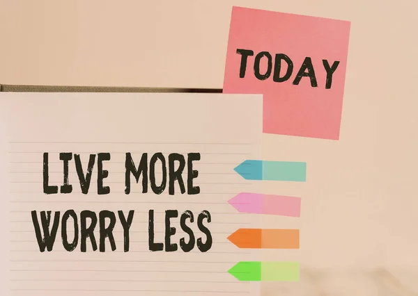 Word writing text Live More Worry Less. Business concept for Have a good attitude motivation be careless enjoy life Hard cover note book sticky note arrow banners inserted clear background. — Stock Photo, Image