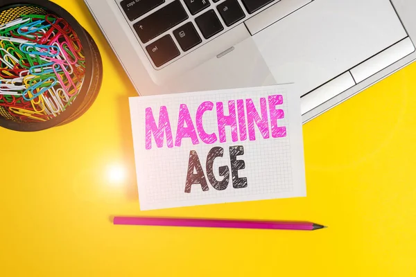 Conceptual hand writing showing Machine Age. Business photo text period of development of new technology and industrial processes Trendy laptop pencil squared paper container colored background.