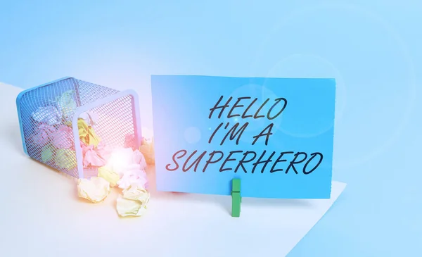 Writing note showing Hello I M A Superhero. Business photo showcasing Believing in yourself Selfconfidence Introduction Trash bin crumpled paper clothespin reminder office supplies.