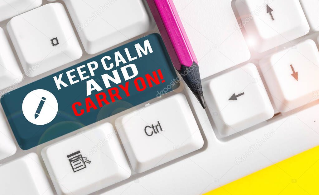 Conceptual hand writing showing Keep Calm And Carry On. Business photo text slogan calling for persistence face of challenge White pc keyboard with note paper above the white background.
