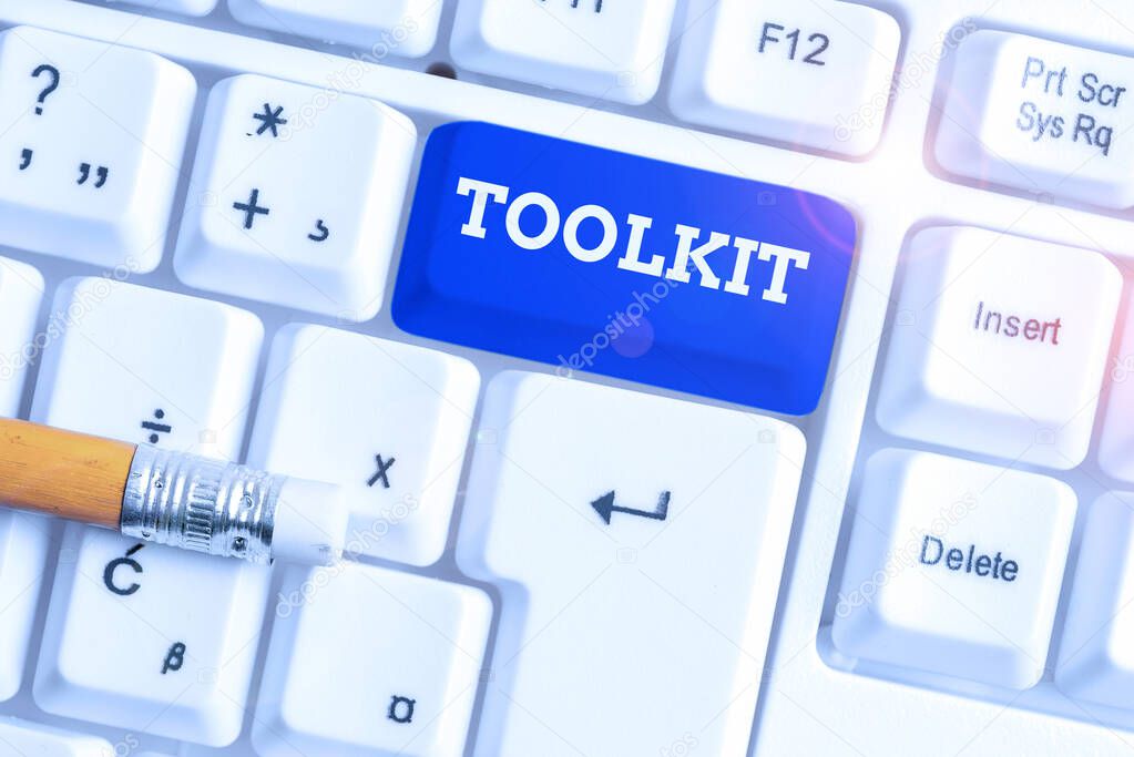 Conceptual hand writing showing Toolkit. Business photo text set of tools kept in a bag or box and used for a particular purpose White pc keyboard with note paper above the white background.