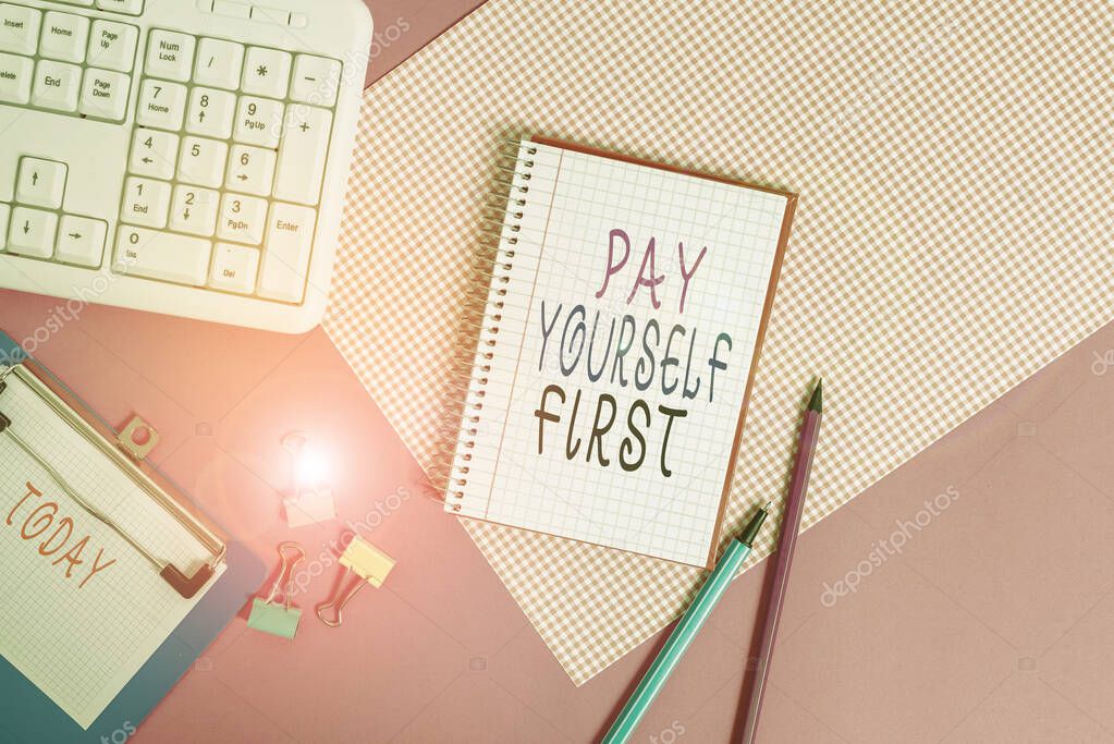 Conceptual hand writing showing Pay Yourself First. Business photo showcasing Saving for future Setting aside a Portion of your income Writing equipments and computer stuff placed on plain table.