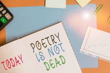 Handwriting text writing Poetry Is Not Dead. Concept meaning aesthetic and rhythmic writing is still alive and modern Striped paperboard notebook cardboard office study supplies chart paper.
