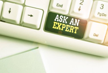 Handwriting text Ask An Expert. Concept meaning consult someone who has skill about something or knowledgeable White pc keyboard with empty note paper above white background key copy space.