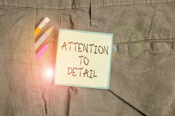 Text sign showing Attention To Detail. Conceptual photo Achieve Thoroughness and Accuracy Exactly Aware Writing equipment and green note paper inside pocket of man work trousers. — Stockfoto
