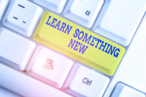 Text sign showing Learn Something New. Conceptual photo being taught new subject activity Knowledge or sport White pc keyboard with empty note paper above white background key copy space. — 스톡 사진