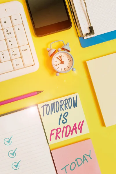 Writing note showing Tomorrow Is Friday. Business photo showcasing Weekend Happy holiday taking rest Vacation New week White paper with copy space with paper clips clock and pc keyboard. — 스톡 사진