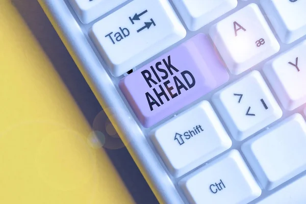 stock image Text sign showing Risk Ahead. Conceptual photo A probability or threat of damage, injury, liability, loss White pc keyboard with empty note paper above white background key copy space.