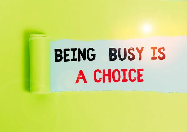 Text sign showing Being Busy Is A Choice. Conceptual photo life is about priorities Arrange your to do list Cardboard which is torn in the middle placed above a plain table backdrop.