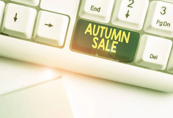 Handwriting text Autumn Sale. Concept meaning having great discounts products on season after summer White pc keyboard with empty note paper above white background key copy space. — Stok fotoğraf