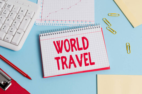 Handwriting text World Travel. Conceptual photo the movement of showing between distant geographical locations Paper blue desk computer keyboard office study notebook chart numbers memo