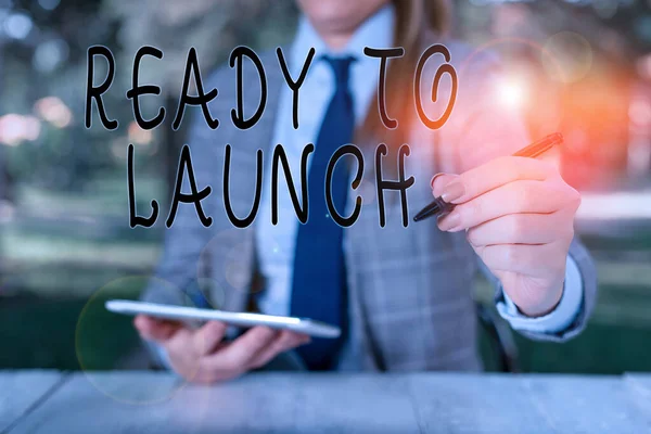 Writing note showing Ready To Launch. Business photo showcasing an event to celebrate or introduce something new to market Female business person sitting by table holding mobile phone. — 스톡 사진