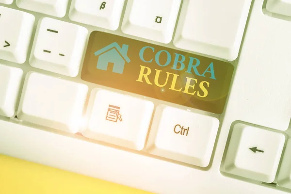 Word writing text Cobra Rules. Business concept for continuing group health insurance coverage after a job loss White pc keyboard with empty note paper above white background key copy space. — ストック写真