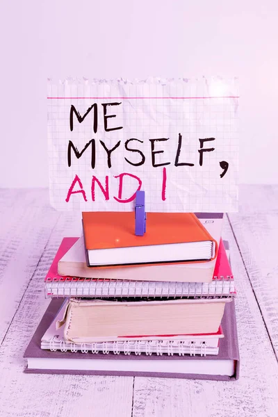 Conceptual hand writing showing Me Myself And I. Business photo text used by speaker to refer to herself as the object of a verb pile stacked books notebook pin color reminder white wooden.