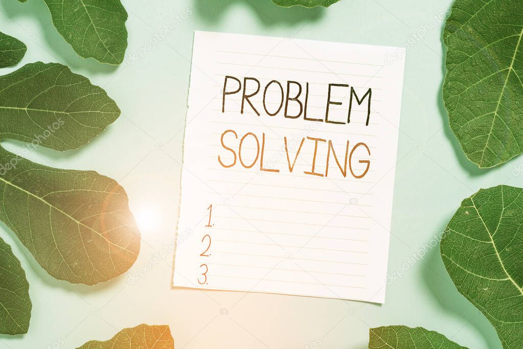 Conceptual hand writing showing Problem Solving. Business photo text process of finding solutions to difficult or complex issues Leaves surrounding notepaper above empty soft pastel table.