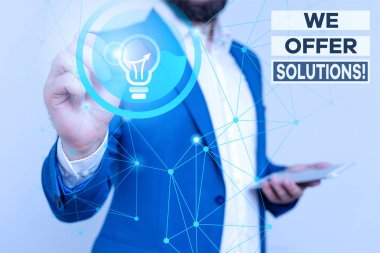 Handwriting text writing We Offer Solutions. Concept meaning way to solve problem or deal with difficult situation Male human wear formal work suit presenting presentation using smart device.