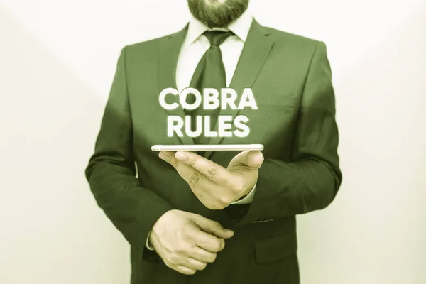 Word writing text Cobra Rules. Business concept for continuing group health insurance coverage after a job loss Male human wear formal work suit hold smart hi tech smartphone use one hand. — ストック写真