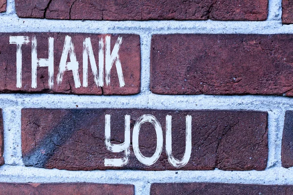 Writing note showing Thank You. Business photo showcasing a polite expression used when acknowledging a gift or service Front view red brick wall facade background Old grunge scenery. — Stock Photo, Image