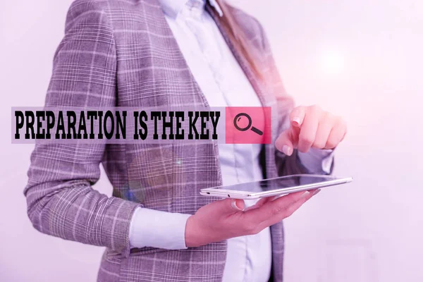 Text sign showing Preparation Is The Key. Conceptual photo it reduces errors and shortens the activities Business concept with mobile phone and business woman.