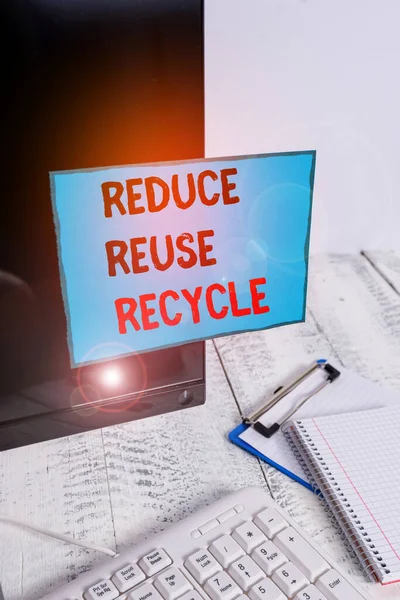 Writing note showing Reduce Reuse Recycle. Business photo showcasing ways can eliminate waste protect your environment Note paper taped to black computer screen near keyboard and stationary. — Stockfoto