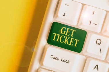 Handwriting text Get Ticket. Concept meaning to have printed paper that permits entry to an event or show White pc keyboard with empty note paper above white background key copy space.