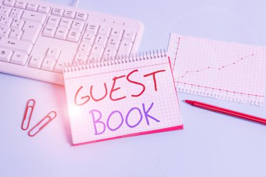 Conceptual hand writing showing Guest Book. Business photo showcasing electronic means for a visitor to acknowledge a visit to a site Paper blue keyboard office study notebook chart numbers memo.