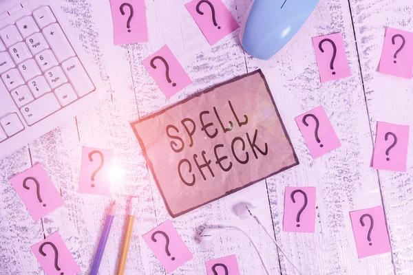 Conceptual hand writing showing Spell Check. Business photo showcasing to use a computer program to find and correct spelling errors Writing tools and scribbled paper on top of the wooden table. — Stok fotoğraf