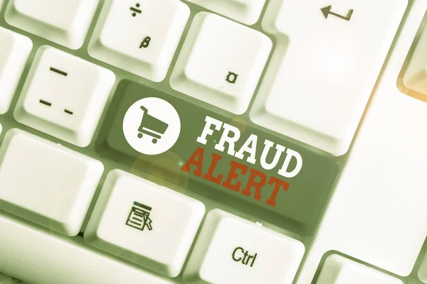 Conceptual hand writing showing Fraud Alert. Business photo showcasing security alert placed on credit card account for stolen identity White pc keyboard with note paper above the white background. — Stock Photo, Image