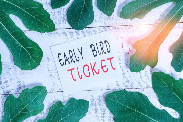 Conceptual hand writing showing Early Bird Ticket. Business photo showcasing Buying a ticket before it go out for sale in regular price Leaves surrounding notepaper above a classic wooden table. — Stock Photo, Image