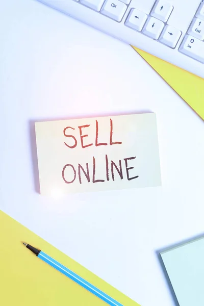 Text sign showing Sell Online. Conceptual photo directly sell goods or services to a buyer over the Internet Flat lay above table with pc keyboard and copy space paper for text messages.