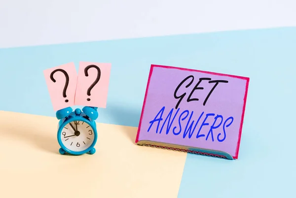 Word writing text Get Answers. Business concept for to get a reply or something when asks a question to someone Mini size alarm clock beside a Paper sheet placed tilted on pastel backdrop. — Stockfoto