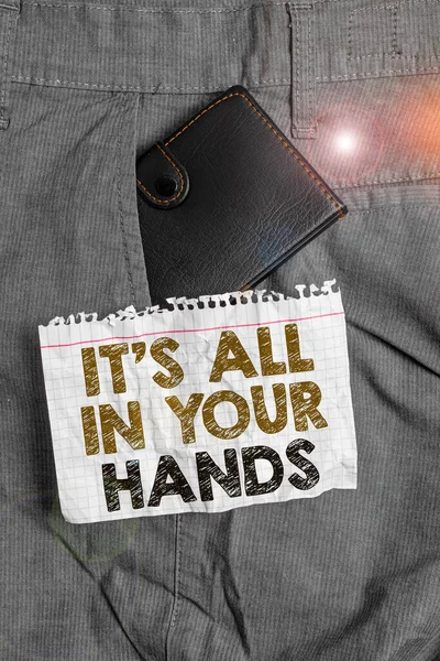 Writing note showing It S All In Your Hands. Business photo showcasing we Hold the Rein of our Destiny and Fate Small wallet inside trouser front pocket near notation paper. — Stock Photo, Image
