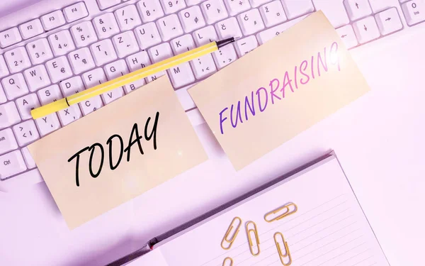 Conceptual hand writing showing Fundraising. Business photo text act of collecting or producing money for a particular purpose Empty orange square papers by the pc keyboard with copy space. — Stock Photo, Image