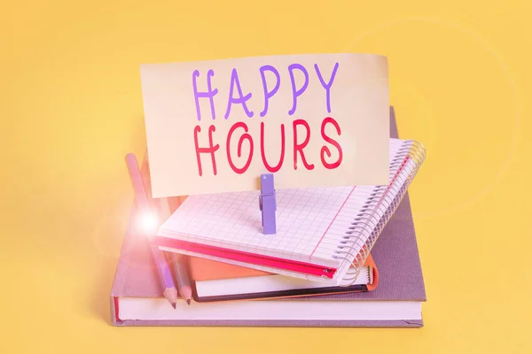 Conceptual hand writing showing Happy Hours. Business photo showcasing when drinks are sold at reduced prices in a bar or restaurant Book pencil rectangle shaped reminder notebook clothespins.