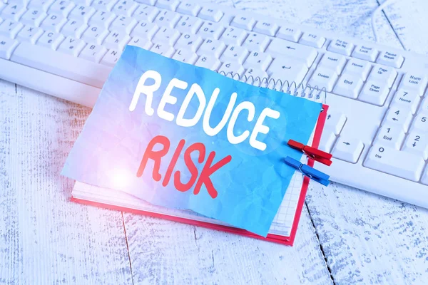 Word writing text Reduce Risk. Business concept for lessen the potential damage that could be caused by a hazard notebook paper reminder clothespin pinned sheet white keyboard light wooden. — Stock Photo, Image