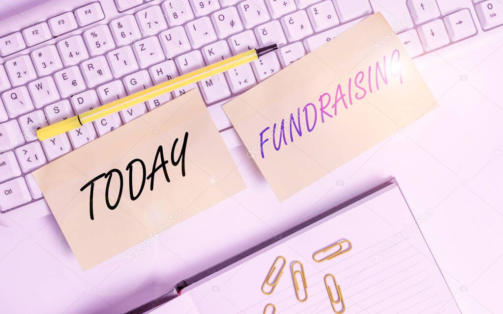 Conceptual hand writing showing Fundraising. Business photo text act of collecting or producing money for a particular purpose Empty orange square papers by the pc keyboard with copy space.
