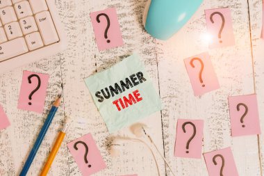Writing note showing Summer Time. Business photo showcasing warmest season of the year Summer season or period like summer Writing tools and scribbled paper on top of the wooden table.