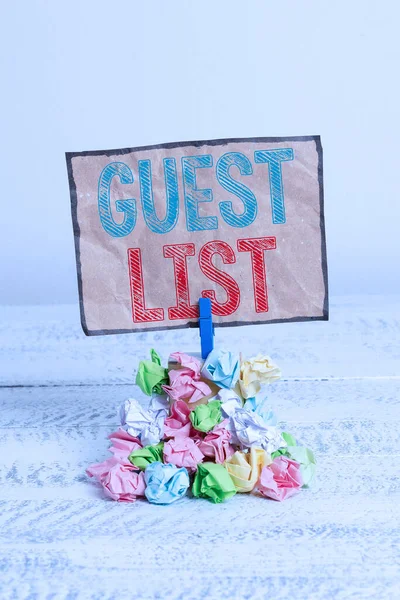 Handwriting text writing Guest List. Concept meaning a list of showing who are allowed to enter the show or an event Reminder pile colored crumpled paper clothespin reminder white wooden space. — Stock Photo, Image