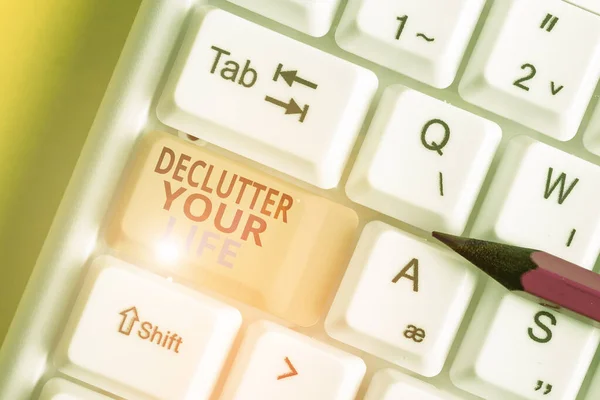 Text sign showing Declutter Your Life. Conceptual photo To eliminate extraneous things or information in life White pc keyboard with empty note paper above white background key copy space. — Stock Photo, Image